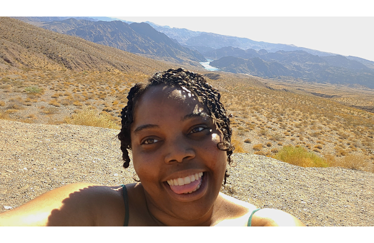 Angelique smiling while viewing a valley outside of Las Vegas.